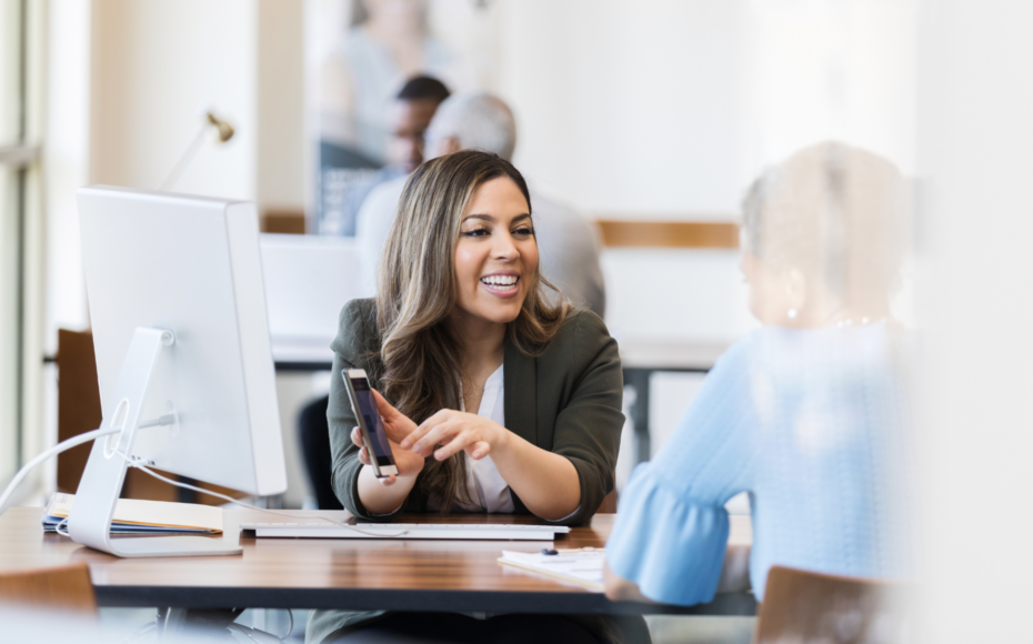 Confident bank manager explains account access to client