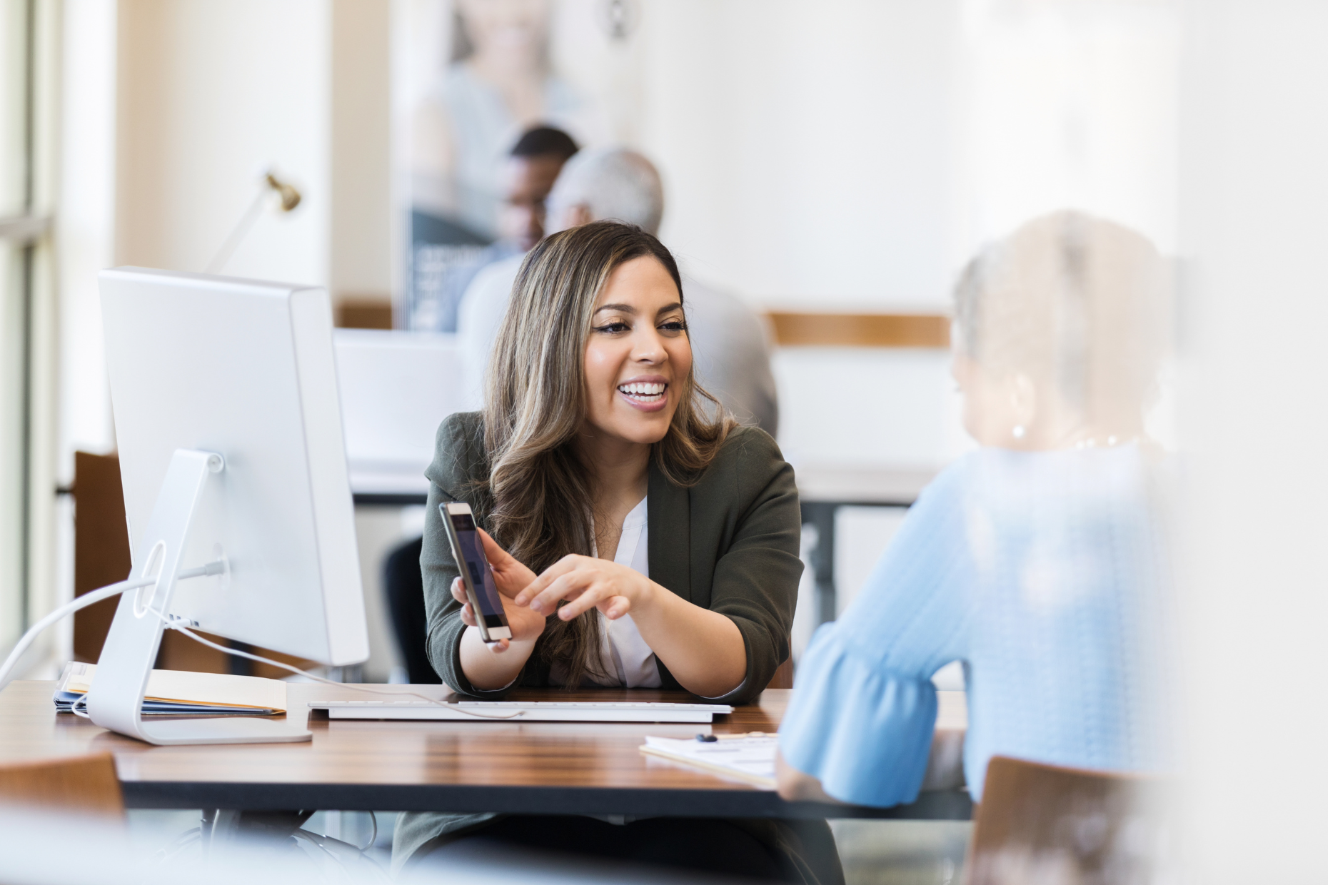 Confident bank manager explains account access to client